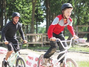 Motopark instructor Zeb Dennis pursues Connor Melady, of Seaforth, during a BMX race on the track.