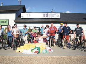 The Devon Cruiser Club, many dressed in superhero garb, gathered together a significant food bank donation before departing for their weekly ride on Wednesday, July 31.