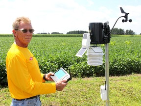 Michael Demeyre, field station operations leader with Dow AgroSciences checks the data collected from this weather station set up at a research field near Blenheim, Ont. on Thursday, Aug. 1, 2013, which showed nearly 16-inches of rain had fallen in the area since July 11, 2013.
ELLWOOD SHREVE/ THE CHATHAM DAILY NEWS/ QMI AGENCY