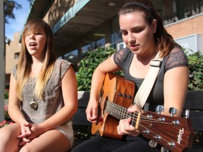 Petrolia acoustic folk duo Erika Sit, left, and Sara Campbell perform in downtown Sarnia. The pair were recently invited to open for Canadian singer-songwriter and Forest native Emm Gryner on four October tour dates. (BARBARA SIMPSON, The Observer)