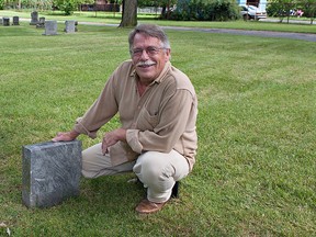 Researcher Bill Darfler shows one of two stones with Arabic script, which may be boundary markers of a Muslim plot in the northeast corner of Mt. Hope Cemetery in Brantford, Ontario on Thursday, August 1, 2013. The plot, dating back to 1912, measures approximately 33 x 33 feet and contains 16 graves, the last burial having taken place in 1963. (BRIAN THOMPSON Brantford Expositor)