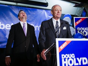 Ontario Tory leader Tim Hudak has a laugh at something said by his newest MPP, Doug Holyday