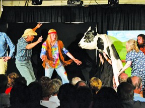 Old Ish (Ish Theilheimer), left, Jack O’Reilly (Ambrose Mullin), and Pinetar (Brennan Duffin), chase a cow during the performance of “I chased Jack and Aggie’s cows” in the Stone Fence Theatre production, “There’s Hippie’s Up the Line!”