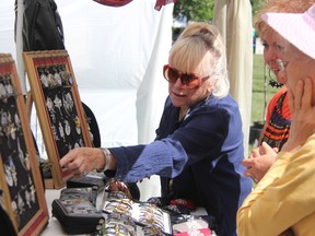 Linda Smith of "Bee Wearables" shows off some of her unique, hand-painted jewelry at Artzscape by the Bay, Saturday. The Oshawa based artist was one of some 40 vendors featured at the first-ever event, a fundraiser for Pathways Health Centre for Children. TARA JEFFREY/THE OBSERVER/QMI AGENCY