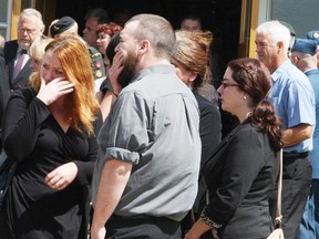 Mourners console each other following the funeral for 28 year-old murder victim Melissa Richmond. The family asked for privacy during the service at CFB Petawawa, which lasted about an hour and attracted about 250 people.
DOUG HEMPSTEAD/Ottawa Sun