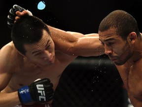 Jose Aldo of Brazil, right fights with Chan Sung Jung of South Korea during the Ultimate Fighting Championship (UFC), a professional mixed martial arts (MMA) competition, in Rio de Janeiro August 3, 2013. (REUTERS/Ricardo Moraes)