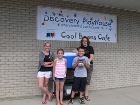 (From left) Kelly Rose Sprenger, Alexa Hryciuk, Hayden Miller and his mom Tammy Miller outside of the Cool Beans Café/Discovery Playhouse with the canteen cart they use as a mobile sales unit.