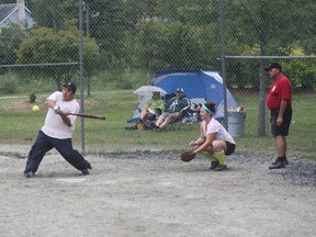 Mike Parisien is about to make contact for the Dirty Dawgs in the Diamonds and Ice mixed slopitch A-side final against Drunken Posse.
LLOYD MACK/Daily Miner and News