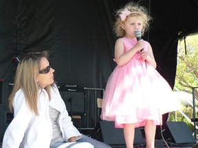 Performing in her first Country Open Singing Contest is Kayla Griffiths, of Sprucedale, while mom Joanne lends on-stage support. Kayla is one of three Griffiths' family members who compete in the event.