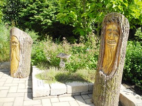 Two carvings, originally on trees in the downtown core, were saved from the wood chipper after the trees were cut down earlier this summer. The carvings are now placed in the garden beside the Delhi Tobacco Museum and Heritage Centre. (SARAH DOKTOR Delhi News-Record)