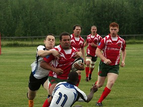 The Strathcona Druids second division men’s rugby team (red) came away with a rare win during the recent Druids Day at the Lynn Davies Rugby Park as they defeated the Fort McMurray Knights 39-7. Photo by Shane Jones/Sherwood Park News/QMI Agency