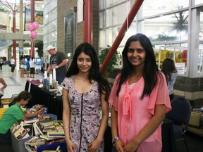 Tanya Varda and Ashlesha Despande, both 17, organized a book sale that raised $800 for Because I am a Girl, a global women’s education charity. ANDREW BATES/TODAY STAFF