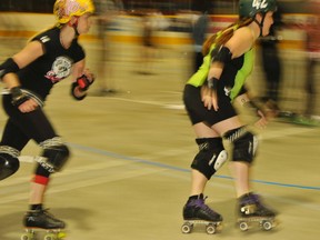 Skaters complete a five-minute time trial at the Team Ontario roller derby try-outs, at the Dr. Edgar LeClair community centre in Azilda, on Aug. 4, 2013. Skaters had five minutes to complete as many laps as possible, and were graded by coaches from all over Ontario.