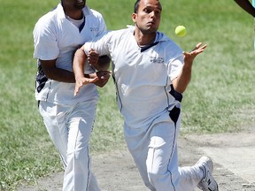 Vikas Poni, right, makes a catch while colliding with North Bay Multicultural Cricket Club teammate Shameer Jabbar Saturday during the 2013 Northern Ontario Cricket Tournament at Amelia Park. JORDAN ERCIT/The Nugget