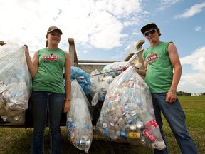 Shelby Kneeland, 18, and Brittaney Broughton, both from New Norway, Alta., collect bottles and cans to raise funds for the Stollery Children's Hospital in the Big Valley Jamboree campgrounds in Camrose, Alta., on Monday, August 5, 2013. Their efforts are part of a mass cleanup operation launched at the conclusion of the four-day festival. Ian Kucerak/QMI Agency