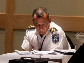 Treaty Three Police chief sitting somberly at his table at the aboriginal police service's 2013 AGM.