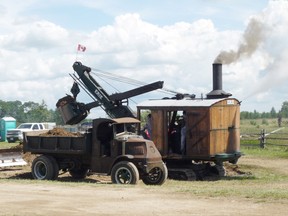 This 1922 Erie model “B” steam shovel, owned by Teeswater Concrete, demonstrates its original function by digging and dumping dirt into a 1929 Mack Dump Truck. Picture was taken at last year’s Bruce County Heritage Farm Show.