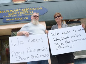 Members of the  Brain Injury Association Quinte District, Clarence Campbell and Jean Hamilton, protest outside the association's downtown Belleville. The pair said members are upset at various board members and feel that they don't actually care about the members.
