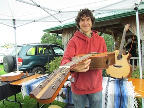Luthier/pyrographic artist Zachary Schryer-Lefebvre displays a guitar he designed and constructed during the Fibre to Fabric Festival Saturday at the Johnson Farmers' Market in Desbarats.