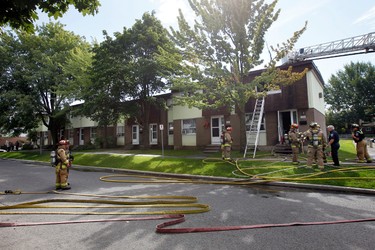 Ottawa firefighters responded to a house fire in an row-house end unit on Debra Ave. Tuesday August 6, 2013. The fire reportedly was caused by electrical malfunction and damage is estimated to be around $60,000.  Darren Brown/ QMI Agency/Ottawa Sun