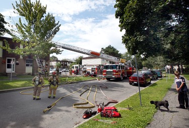 Ottawa firefighters responded to a house fire in an row-house end unit on Debra Ave. Tuesday August 6, 2013. The fire reportedly was caused by electrical malfunction and damage is estimated to be around $60,000.  Darren Brown/ QMI Agency/Ottawa Sun