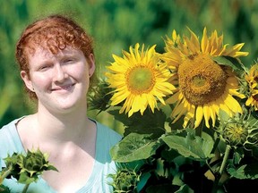 Victoria Dewar, 14, stands among some of the blooming sunflowers that stand in the family garden thanks to Nightlock the black bear hamster. (SCOTT WISHART The Beacon Herald)