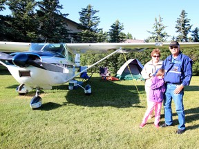KASSIDY CHRISTENSEN NANTON NEWS/QMI AGENCY Garry Wutzke, with wife Marg Wutzke and granddaughter Kiara Wutzke, flew from Calgary to the ranch the night before the fly-in and camped out under the wing of his Cesna 182.