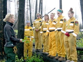 ESRD Wildfire Ranger Margriet Berkhout (left) talks about the Lodgepole wildfire and forest ecosystem to a group of Alberta Junior Forest Rangers and their leaders. The program is designed for those considering a career in forestry.