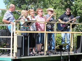 KASSIDY CHRISTENSEN NANTON NEWS/QMI AGENCY From left, Jeff Enfield, Danielle McRae, Cori Shields, Cheryl Lundberg, Sten Lundberg and Matt Wall sang and played cheerful worshipping tunes during the outdoor church service.