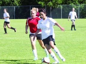 Lizel DeGagne of Taggs is tracked by Haley Pentek of Vanz during play in the Kenora Women’s Soccer Tournament in July. The local league’s six teams are moving into the playoffs with the quarterfinal games taking place tonight, Aug. 7.
LLOYD MACK/KENORA DAILY MINER AND NEWS