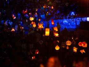 The volunteer lantern procession winds up the hill during the 2012 Edmonton Folk Festival at Gallagher Park. The parade takes place every year at the festival, giving volunteers a chance to shine. File Photo/QMI Agency