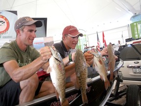 2012 KBI champions Peter Tully and Aaron Wiebe show off four of their smallmouth bass that they caught on the final day of the 25th anniversary tournament. Their three-day total of 52.61 lbs earned them the title.
FILE PHOTO/Daily Miner and News