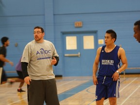 Keyano Huskies head coach David Petroziello provides instruction to Carl Batanya Tuesday night at the YMCA in Thickwood. Players have been training at the YMCA, using the weightroom and gym to prepare for the 2013-14 ACAC season.  ROBERT MURRAY/TODAY STAFF