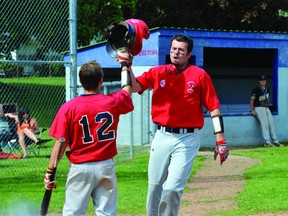 Brockville Bunnies' John Kalivas is congratulated at home plate by Devin Burns after his fifth-inning homer during the second game of a doubleheader against Gatineau in May. It has been an oustanding season for a young Bunnies team on both the Quebec league and tournament circuits. (RECORDER AND TIMES FILE PHOTO)