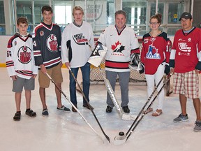 Brant MP Phil McColeman is joined on the ice Wednesday by Alexander Polillo (left) of the Brantford 99ers AAA major bantams, Guy Polillo of the junior B 99ers, Zac Dalpe of the Carolina Hurricanes, Burford's Emma Woods, who plays in the Provincial Women's Hockey League, and the Brantford Blast's Cameron Sault to promote Hockey Night in Brantford on Aug. 14. (Brian Thompson, The Expositor)