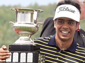 Nicholas Scrymgeour holds the inter-provincial trophy after his team’s win at the junior golf championships in Sudbury, ON.