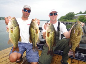 Jay Samsal and Scott Dingwall hold up a mixed bag of smallmouths and largemouths from Shoal Lake.  A mixed bag strategy will likely prevail at the 2013 KBI. 
JEFF GUSTAFSON/The Livewell