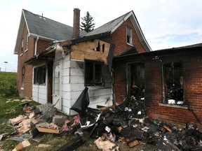 The remains of the house rented by the Mitchell family that caught on fire Saturday evening. (JAMES MASTERS/QMI AGENCY)