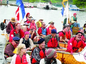Paddlers from the Voyageur Brigade Society arrive at shore at Seeley's Bay after a day-long paddle up the Rideau Canal. (WAYNE LOWRIE photo)