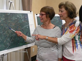 Trout Lake resident Jill Labreche, left, discusses an Algonquin land claim map with Linda Thomas, of London, who has summered on the lake since the 1950s.