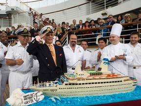 Actor Gavin MacLeod (2nd L), who portrayed Captain Stubing from television series “The Love Boat”, salutes as crew members and friends sing happy birthday as he celebrates his 80th birthday, which was on February 28, onboard Princess Cruises Golden Princess cruise ship in the Port of Los Angeles March 2, 2011 in this publicity photograph. REUTERS/Susan Goldman/Princess Cruises/Handout