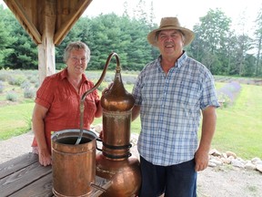 Barb and Bob Gillies pose with their lavender distiller at their Drumbo Road farm near Paris, Ontario. The former hog farmers have a small hobby farm based around lavender. MICHAEL PEELING/The Paris Star/QM Agency