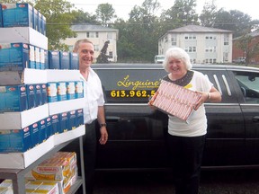Michael Petrella, owner of Linguine’s Italian Restaurant in Belleville, donated a limo-full of pasta and other items to the Gleaner's Food Bank on Friday. Shown here is Susanne Quinlan, Gleaners Food Bank director of operations accepting the donations. Petrella uses the tips from Linguine’s limo service to purchase the food to donate to the food bank.