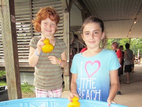 The 19th annual Summerfest in Turkey Point began in earnest Thursday with a Kids Day celebration in the pavilion on Tom Millar Lane. Trying their luck at the duck pond were Cheyenne Sherman, left, of St. Williams, and cottager Ella Hayes, of Turkey Point. (MONTE SONNENBERG Simcoe Reformer)