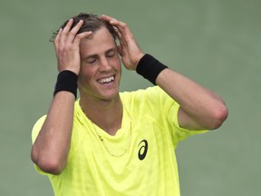 Canadian Vasek Pospisil celebrates after upsetting Czech Tomas Berdych to reach the quarterfinals of the Rogers Cup in Montreal, August 8, 2013. (MARTIN CHEVALIER/QMI Agency)