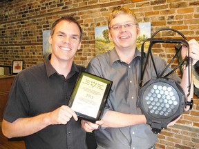 Derek Ritschel, artistic director at the Lighthouse Festival Theatre and Sam MacLeod, technical and production director at the theatre show off one of the new energy efficient lights the theatre will be able to purchase thanks to funds from the Ontario Trillium Foundation. (SARAH DOKTOR Simcoe Reformer)