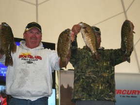 Bill Godin, left, and Leroy Wilson, right, hold up four of their five bass for the first weigh in of the 2013 Kenora Bass International. The pair’s 18.44 lbs catch put them in second place behind Jeff Gustafson and Chris Savage’s 19.78 lb catch.
GRACE PROTOPAPAS/KENORA DAILY MINER AND NEWS
