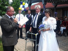 Rev. Don McPherson, left, of Talbotville United Church, speaks during a wedding ceremony for Gord and Lisa McDonald at Caressant Care, Bonnie Place on July 24. The McDonalds met at Caressant Care last winter.