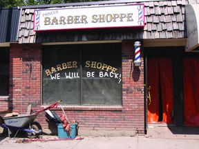 KEVIN RUSHWORTH HIGH RIVER TIMES/QMI AGENCY The Pioneer Barber Shoppe is one of 50 local businesses interested in a site at the new temporary business park. Their window sign is one of many popping up around town reassuring residents they will reopen.
