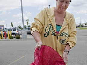 Wendy Rumble shows a sky lantern that landed recently near her Durham Street home in Brantford, Ontario and is concerned about the possibility of one starting a structure on fire when it lands. (BRIAN THOMPSON Brantford Expositor)